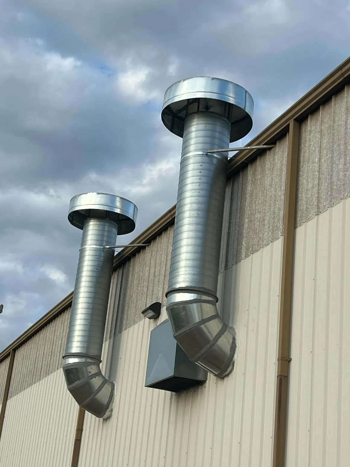 Industrial exhaust duct stacks on a building